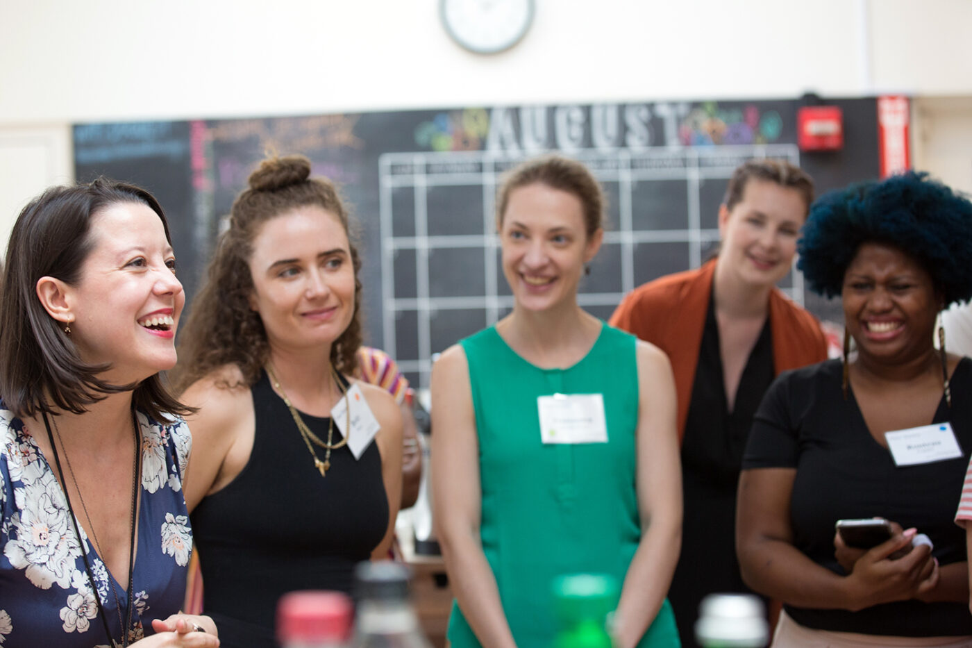 group of women standing and laughing